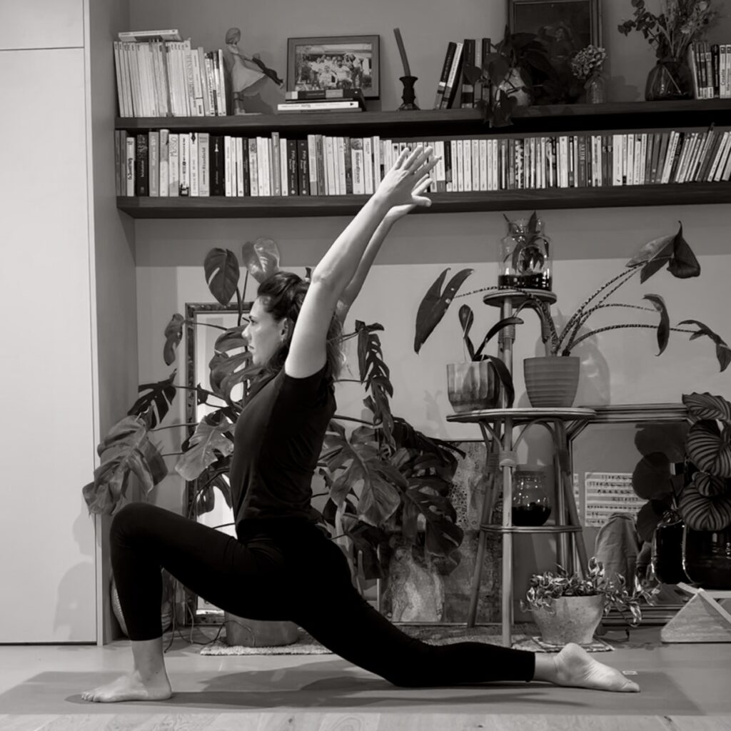 Personne en posture de yoga, ancrée et concentrée, dans une ambiance calme.